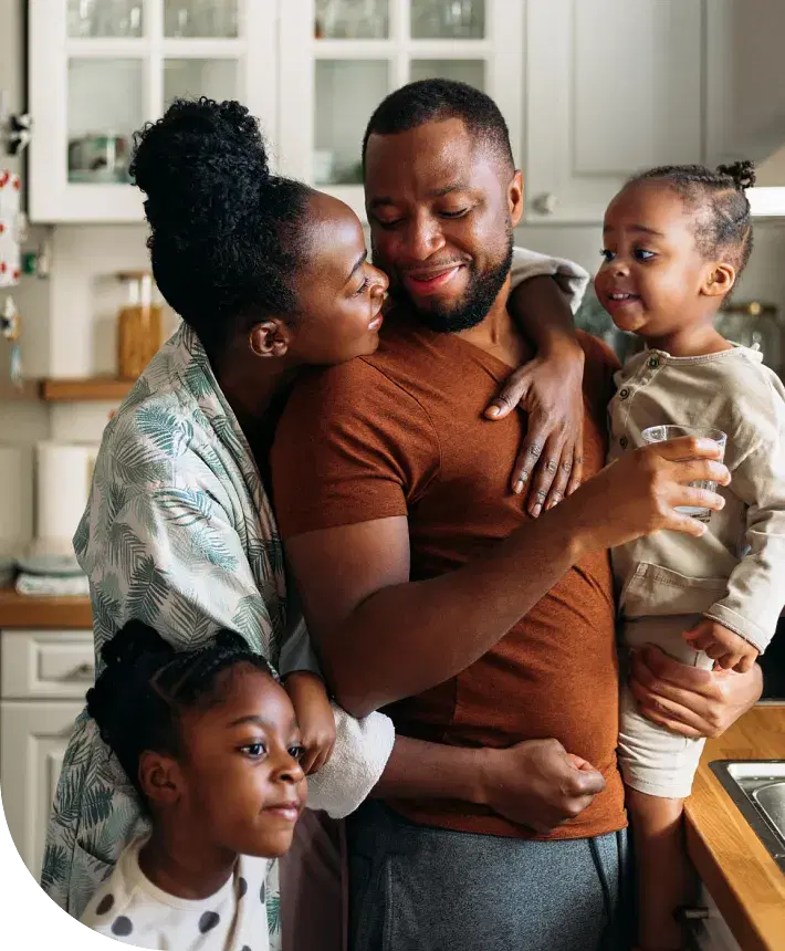 A smiling family in a kitchen setting