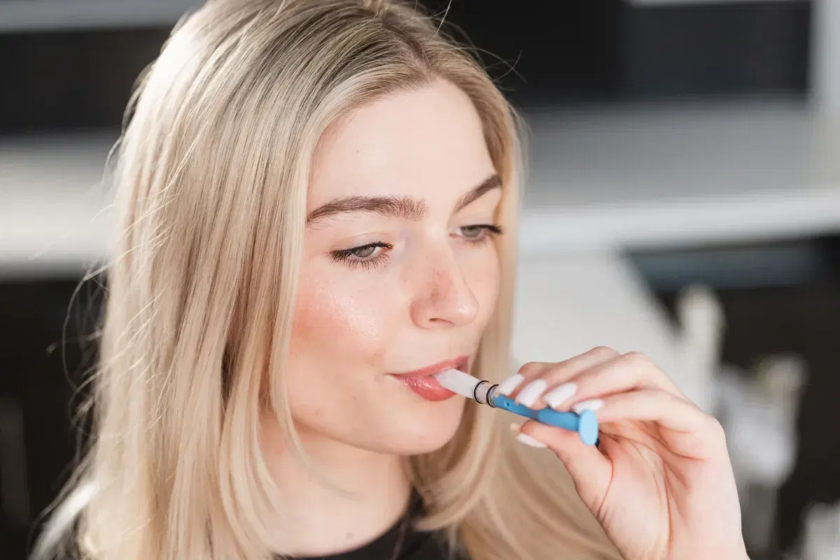 Person collecting a saliva sample with the Oral Genome sponge
