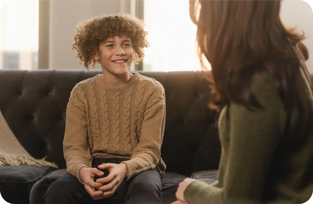 Couple smiling and brushing teeth together, representing oral wellness awareness